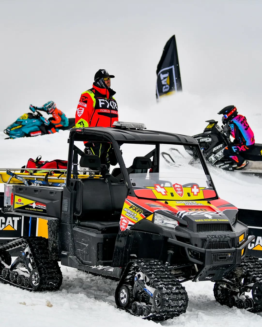 A Mobile Medical responder beside the tracked Polaris Ranger at the side of the course